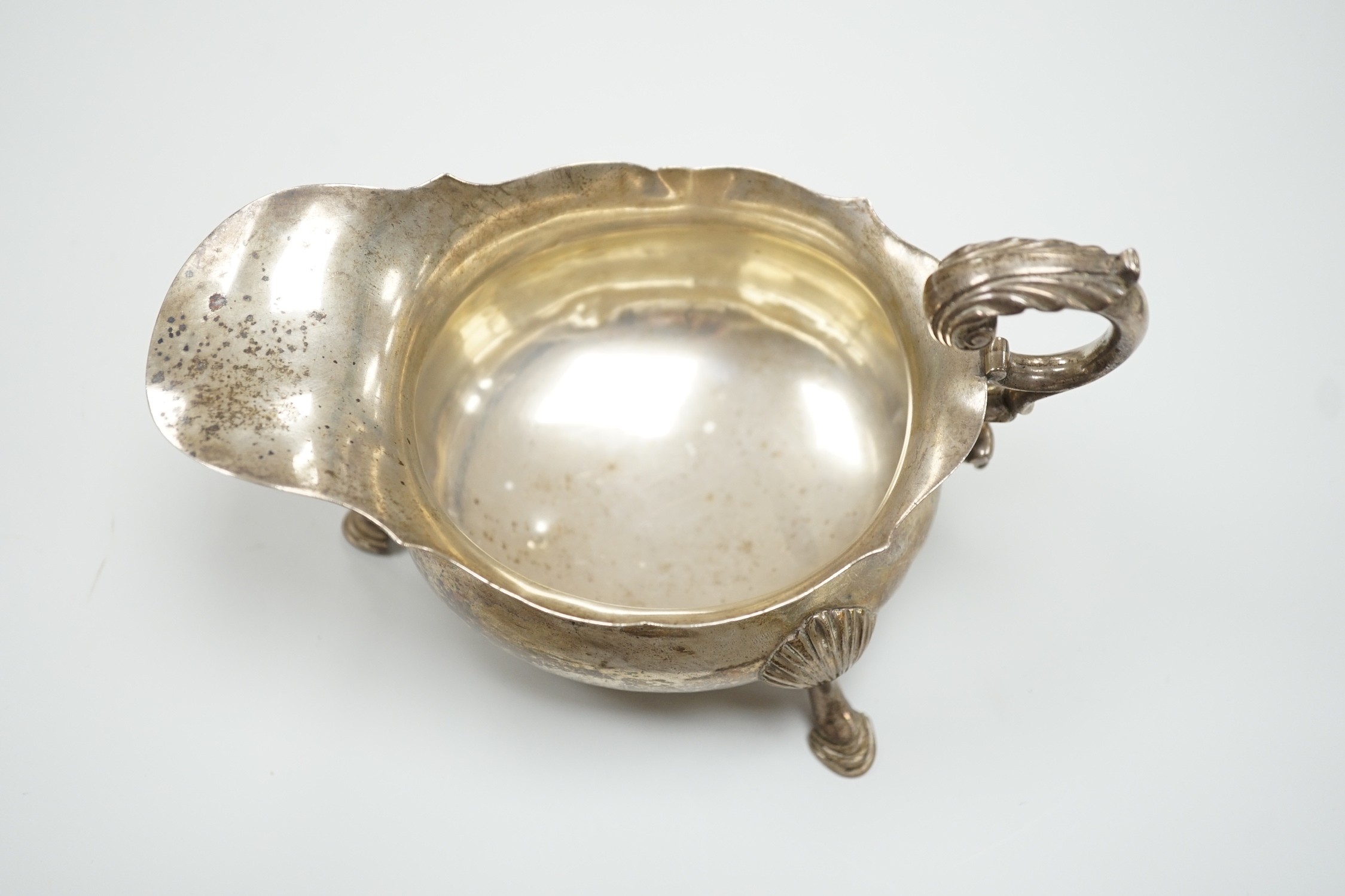 A William IV silver sauceboat, with flying scroll handle, Michael Starkey, London, 1831, length 17.8cm, 8.6oz.